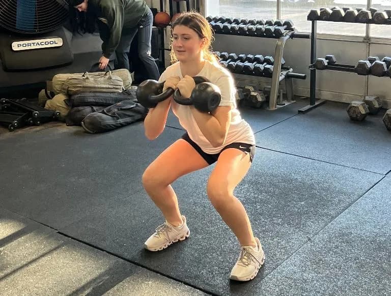 A young NEPA Fit Club athlete doing a kettlebell squat